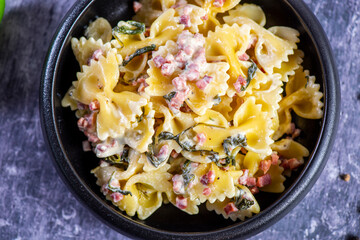 Carbonara pasta. Farfalle with pancetta, egg, parmesan cheese and cream sauce.