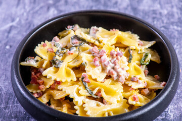 Carbonara pasta. Farfalle with pancetta, egg, parmesan cheese and cream sauce.