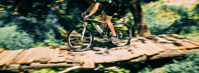 Mountain Bike cyclist riding track at sunny day, healthy lifestyle active athlete doing sport