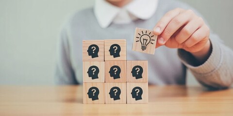 Problem-Solving and Innovation Concept with Professional Placing Light Bulb Block on Stack of Question Mark Blocks, Representing Creative Thinking, Solutions, and Strategic Decision-Making