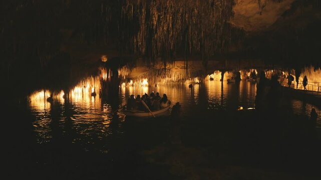 A group of people on a boat at Drach caves in Mallorca, Spain