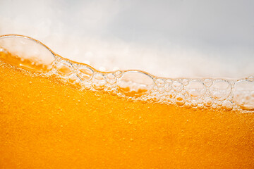 Close up bright orange Oil or beer splash texture and nature waves, Beautiful waves curve and little bubbles smooth for graphic design and background, Oil Bubbles, Soft beer bubbles, Selective focus