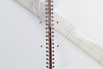 Open blank spiral bound squared notebook with drawing accessories