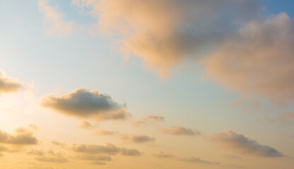 Obraz premium Background of clouds and orange sky in the morning,Beautiful Vivid sky painted by the sun leaving bright golden shades