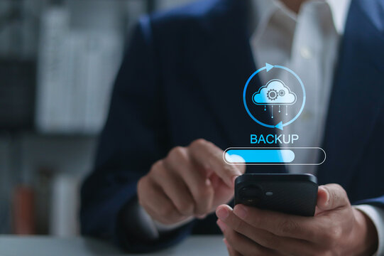 Backup concept, Online digital data storage and connection service. Businessman using smartphone with backup status bar for data backup management. - Powered by Adobe
