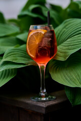 Aperol spritz cocktail with lemon and ice in a glass