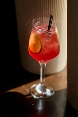 Aperol spritz cocktail with lemon and ice in a glass