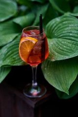 Aperol spritz cocktail with lemon and ice in a glass