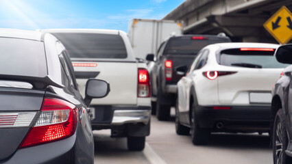 Luxury of grey car driving on the road. Many cars turn on brake light. Traveling in the provinces during the bright period. ridge with sign board for Intersection symbol background.