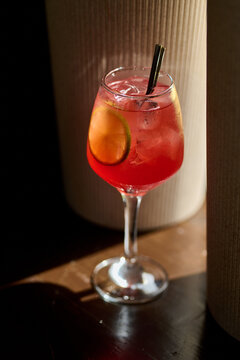 Aperol spritz cocktail with lemon and ice in a glass
