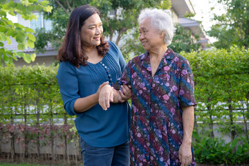 Asian elderly woman hug with her daughter with love, care, help, encourage and empathy at park,...