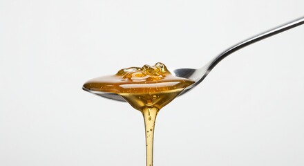 Honey drips from spoon, healthy food ingredient, white background, food photo