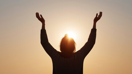 Person in silhouette prays under a glowing sunrise, embodying faith and hope during Lent and Easter season