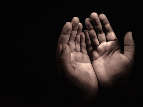 Muslims prayer and supplication to almighty for forgiveness. Raising hands to make dua during in silence of the night. Faith in Islamic religion.