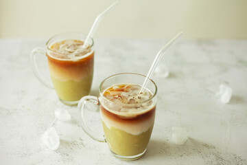 Refreshing pistachio iced latte in a clear glass, capturing cool summer vibes and laid-back...
