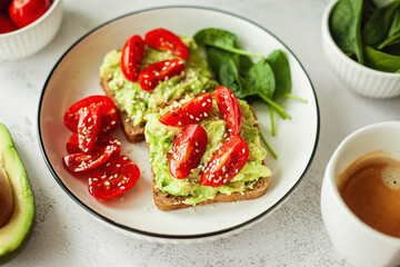 Wholesome healthy breakfast vegan avocado sandwich on wholewheat bread, topped with fresh cherry tomatoes — a clean, nourishing choice for mindful eating and balanced living