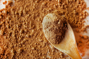 Cocoa Powder and Wooden Spoon.Top View with Texture