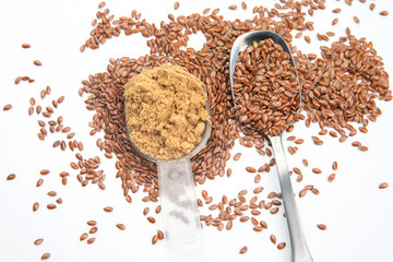 ground flaxseed and oil on white background