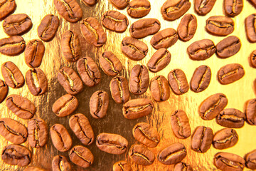 Roasted coffee beans in an oval formation on a reflective golden surface, highlighting their smooth surfaces and brown hues. Great for beverage marketing.