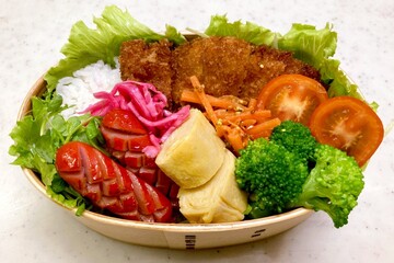 A traditional Korean dosirak, beautifully arranged with rice, assorted banchan, and savory proteins. Balanced and visually inviting, it’s a portable meal packed with vibrant flavors.
