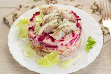 Homemade vegetable salad with potatoes, carrots and fish