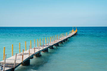 Wooden Pier Extending into the Blue Ocean