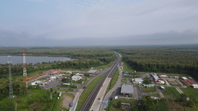 Aerial view of a rest area in Ngawi, East Java, with toll road and rice field.