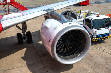 Close up jet engine and propeller and refuel truck in airfield
