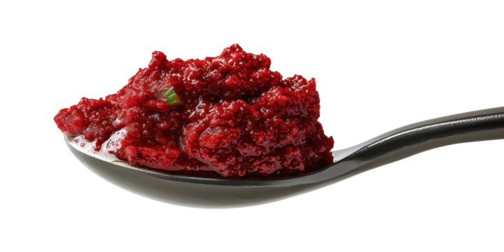 A spoonful of gochujang (Korean chili paste) suspended mid-air with soft curve, pure white background