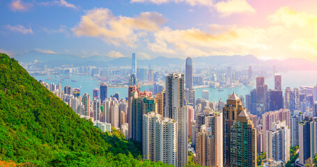 Aerial panorama top view of forest peak slope of high rise skyscrapers cityscape of Hong Kong