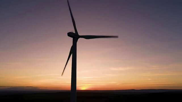 Wind Turbine Silhouetted Against a Vibrant Sunset Sky