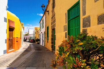 Colorful alley with green doors and historic facades in Agüimes, Gran Canaria