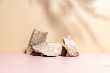 A stylish stone pedestal resting on a neutral beige surface, framed by soft shadows—ideal for...