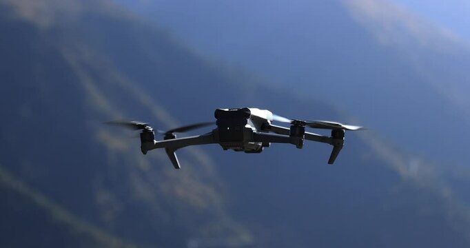 Flying drone taking off in summer grassland