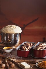 Fingers dusted with flour expertly knead and shape silky yeast dough, showcasing its elasticity and texture against a rustic backdrop, embodying the art of baking