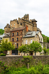 Castle of Estaing on a cloudy day from the banks of the Lot