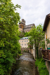 Castle of Estaing on a cloudy day from the banks of the Coussane River