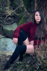 Tranquil Outdoor Scene with Woman by Tree Beside Calm Stream