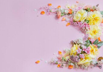 frame of summer flowers on pink paper background