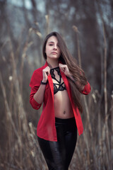 Confident Woman in Stylish Outfit Posing Outdoors