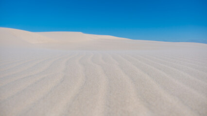 Endless white sand dunes under the bright blue sky in Denmarks tranquil landscape