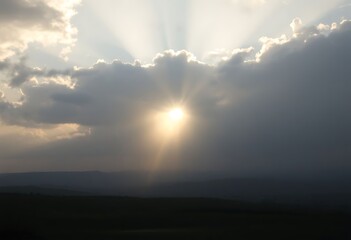 Fototapeta premium sun is shining through the clouds in the sky