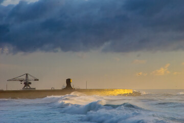 Old harbor wall at sunset