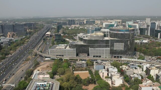 Drone Shot of DLF Cyber City Gurgaon &ndash; Aerial View of Iconic IT Hub with Glass Towers, Office Buildings, Skywalk, Metro Line, and Modern Infrastructure in Gurugram, India