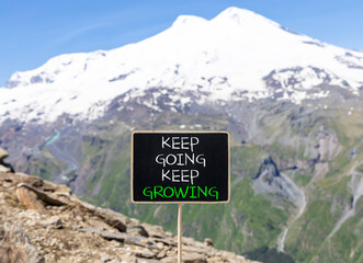 Keep going and growing symbol. Concept words phrase Keep going keep growing on beautiful black...
