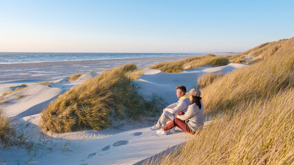 Couple enjoying peaceful sunset on the sandy shores of Denmarks picturesque beach