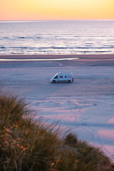 Coastal camping adventure at sunset in a serene Danish beach landscape