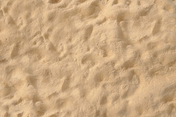 Textured Sand Surface Background with Natural Patterns and Earthy Tones for Design Projects