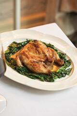 Portion of gourmet baked chicken with spinach