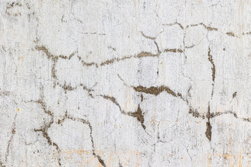Close-up of cracked textured concrete wall surface with natural patterns